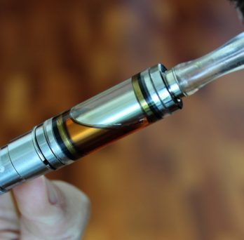 A person uses a vaping device.
                  